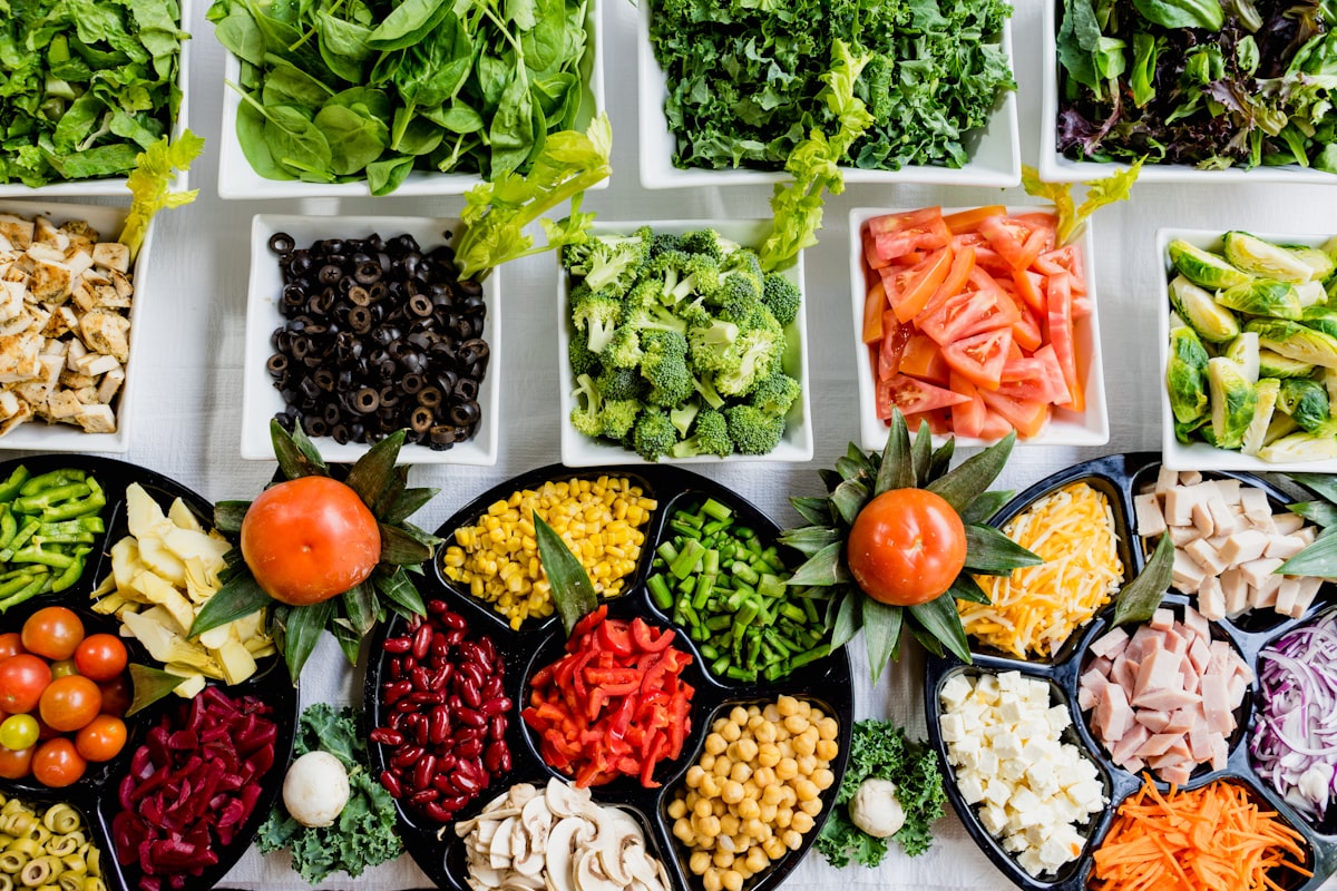 Fresh produce and leafy greens on kitchen counter